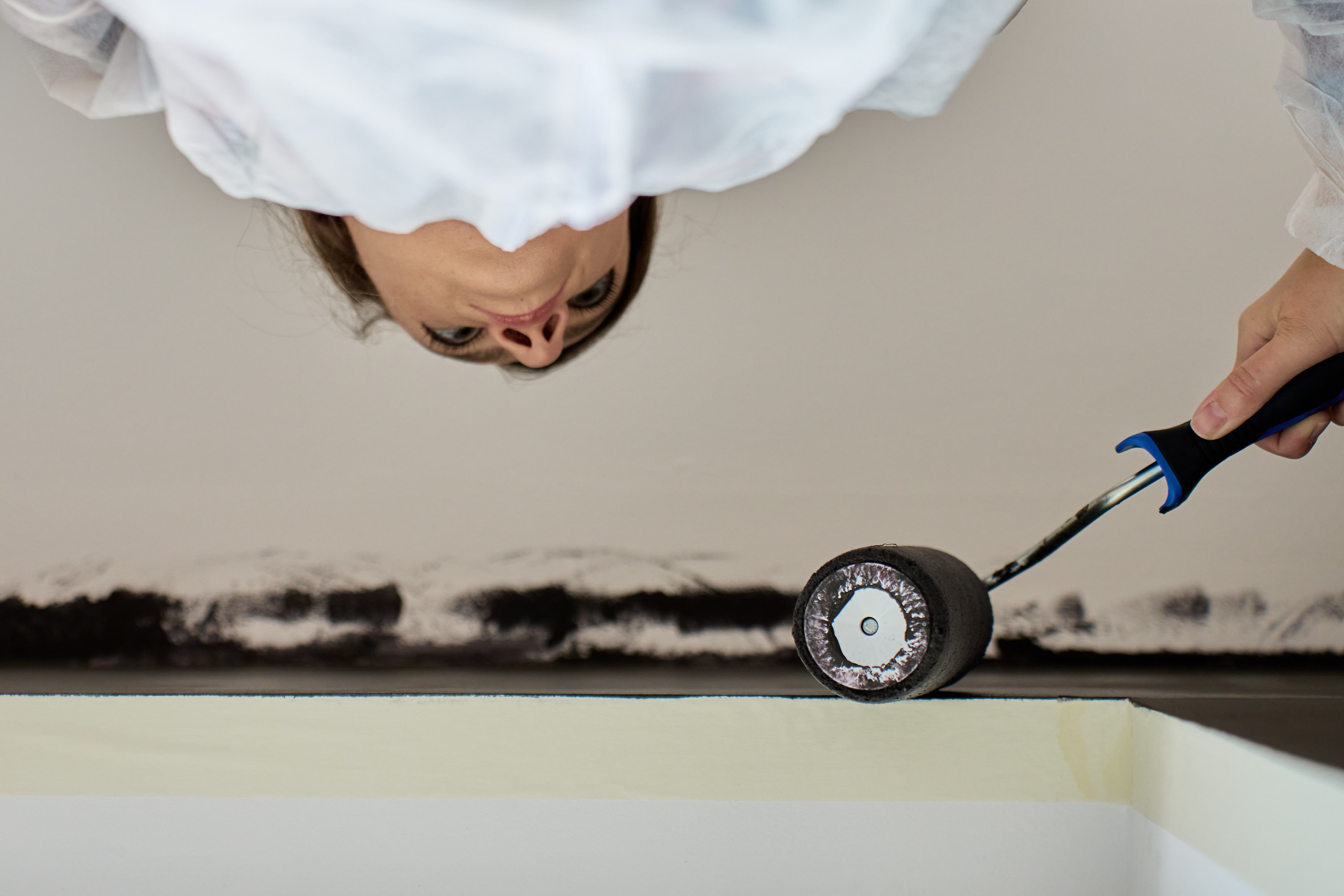 close-up-of-woman-painting-ceiling-and-wall-with-r-2025-06-30-07-41-30-utc close-up-of-woman-painting-ceiling-and-wall-with-r-2025-06-30-07-41-30-utc